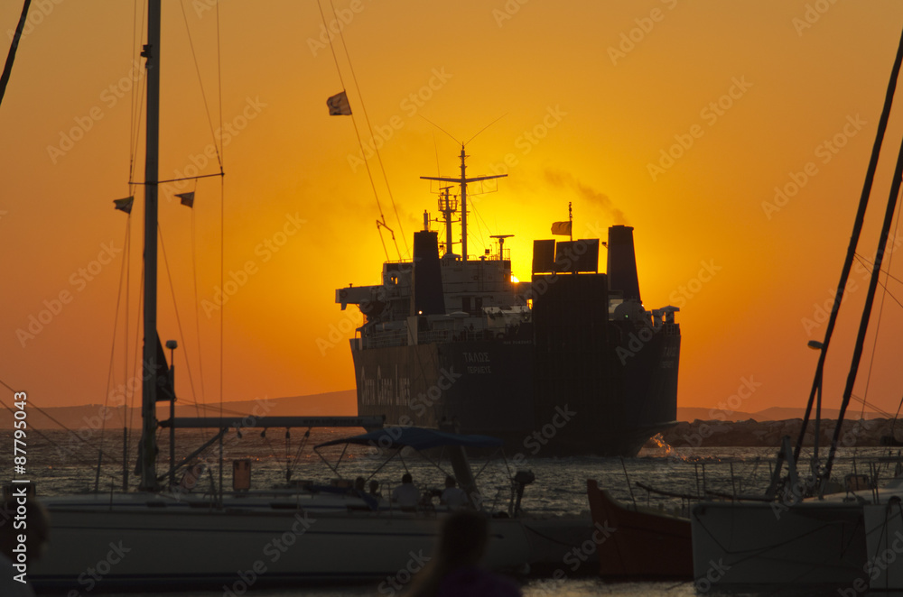 A cargo ship leaves Naxos at sunset_II
