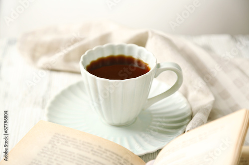 Still life with cup of coffee and book, close up photo