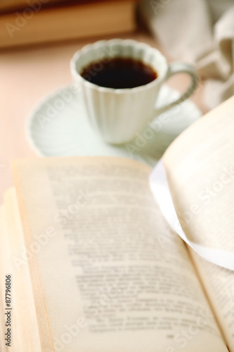 Still life with cup of coffee and book, close up