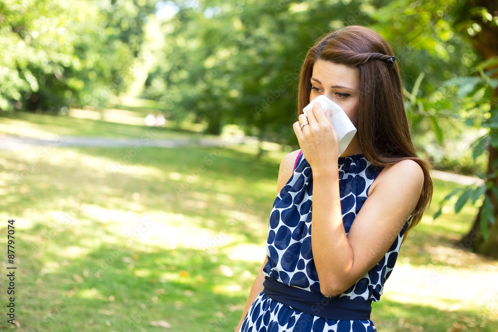 young woman with hay fever blowing her nose. young woman with hay fever blowing her nose.