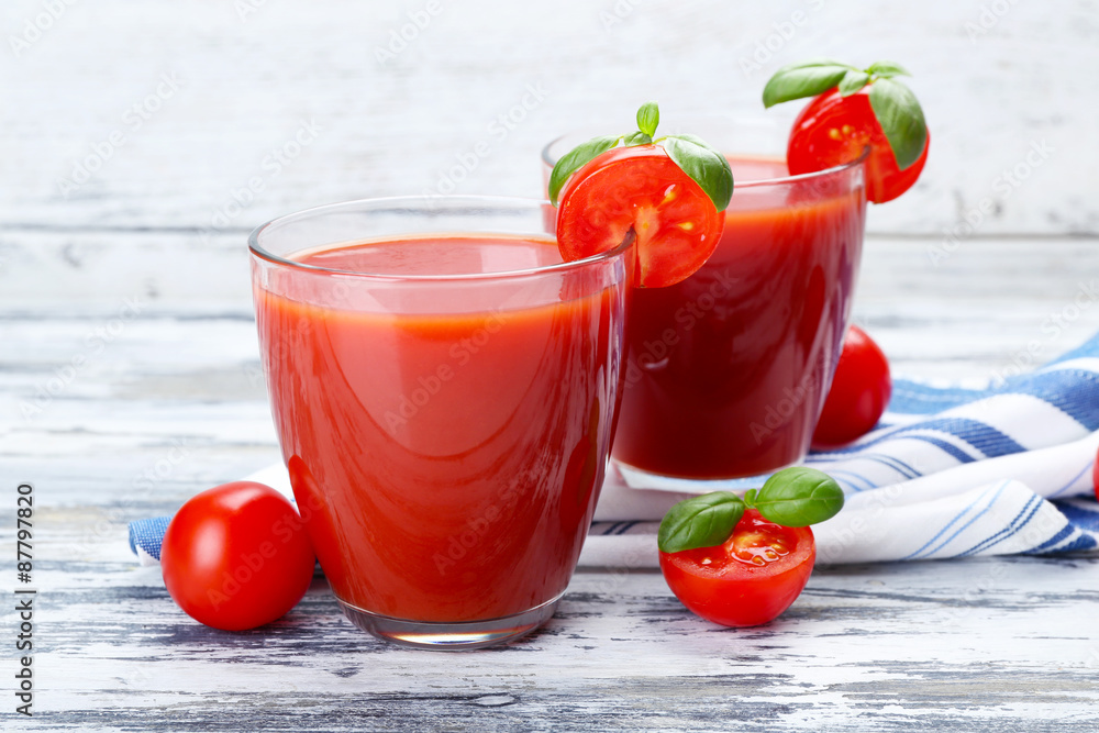 Glasses of tomato juice with vegetables on wooden background Glasses of tomato juice with vegetables on wooden background