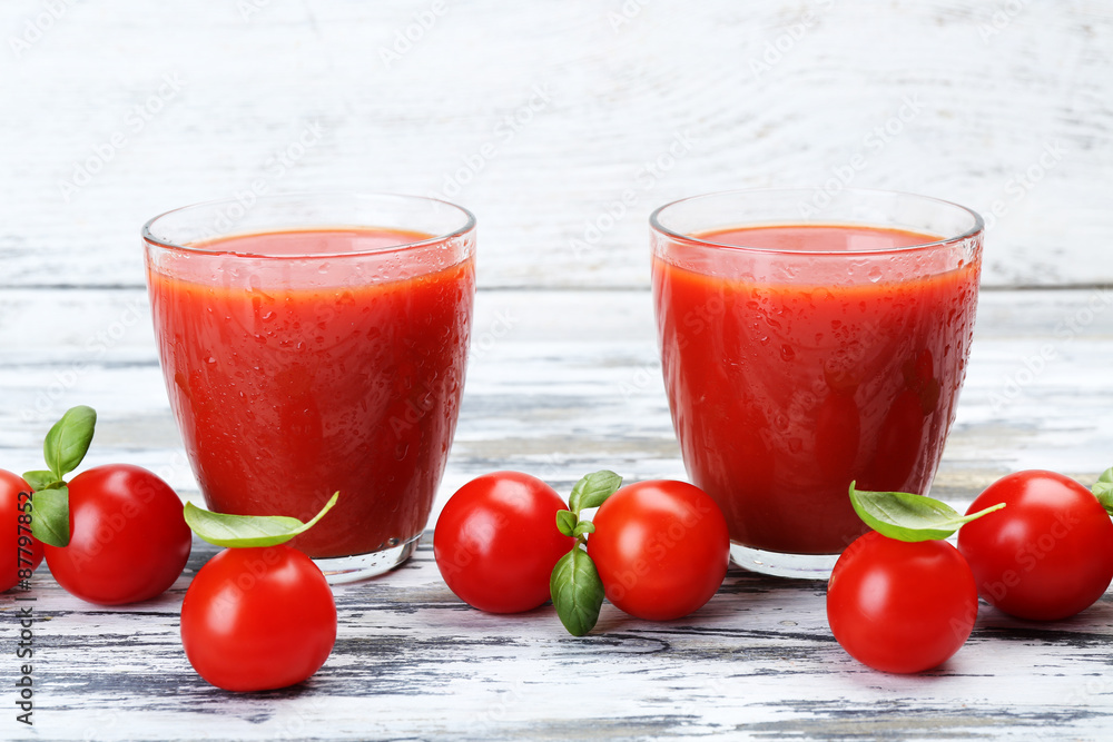 Glasses of tomato juice with vegetables on wooden background Glasses of tomato juice with vegetables on wooden background