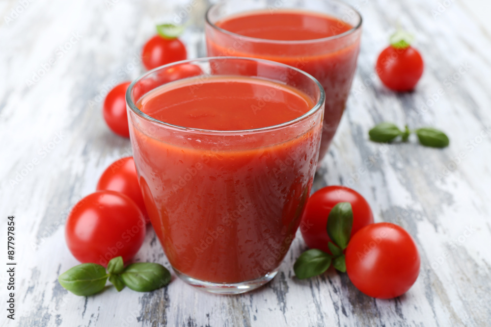 Glasses of tomato juice with vegetables on wooden background Glasses of tomato juice with vegetables on wooden background