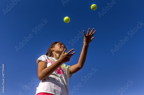 Looking up at girl juggling.