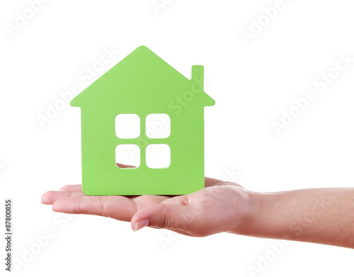 Female hand with small model of house isolated on white