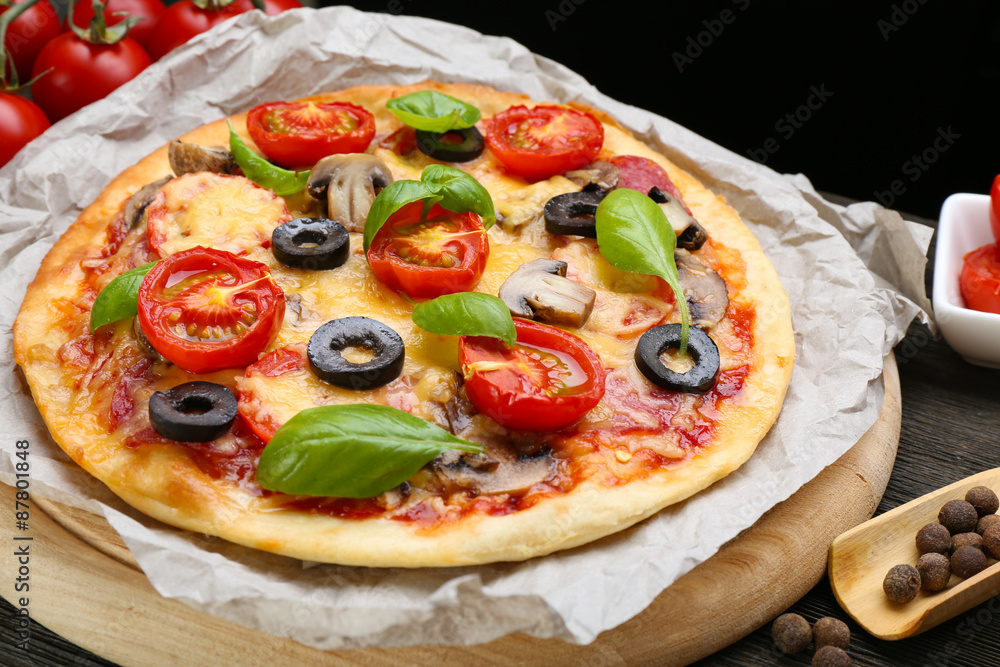 Tasty pizza with vegetables and basil on table close up Tasty pizza with vegetables and basil on table close up