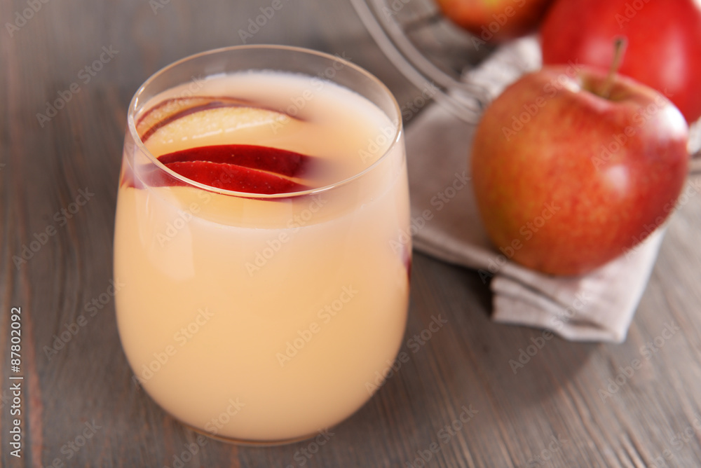 Glass of apple cider with fruits on wooden background Glass of apple cider with fruits on wooden background