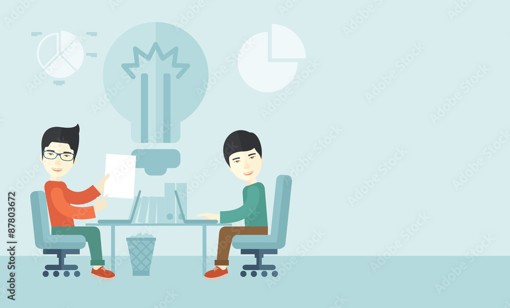 Two japanese businessmen sitting working together. Two japanese businessmen sitting working together.