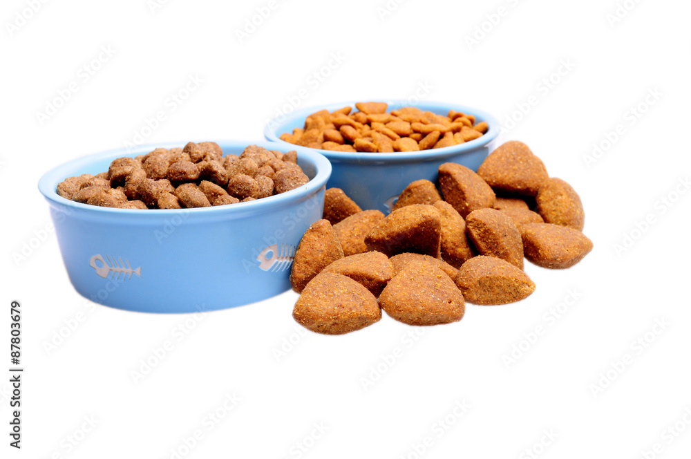 Blue ceramic dogs bowl. Dry dog food in bowl isolated on white background. Blue ceramic dogs bowl. Dry dog food in bowl isolated on white background.