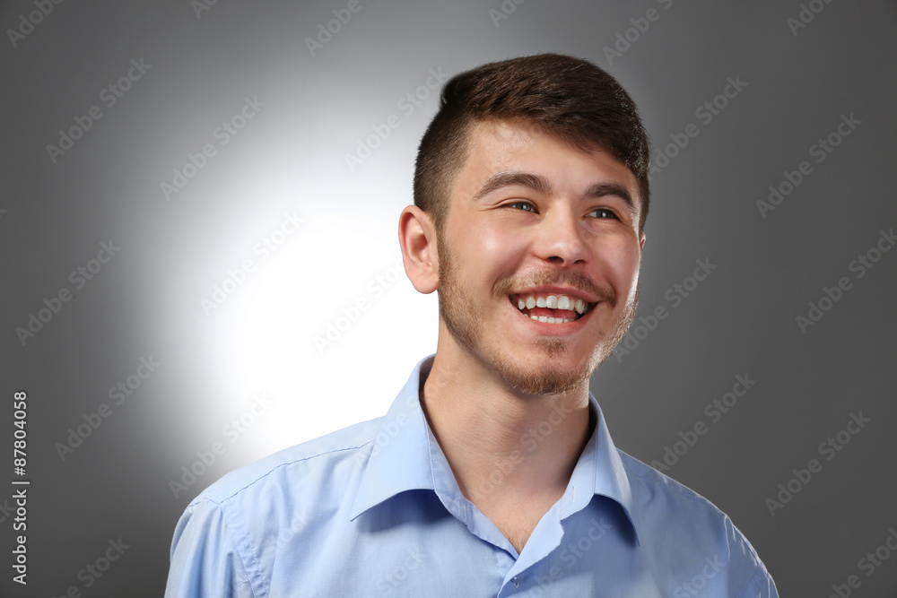 Portrait of smiling man on gray background Portrait of smiling man on gray background