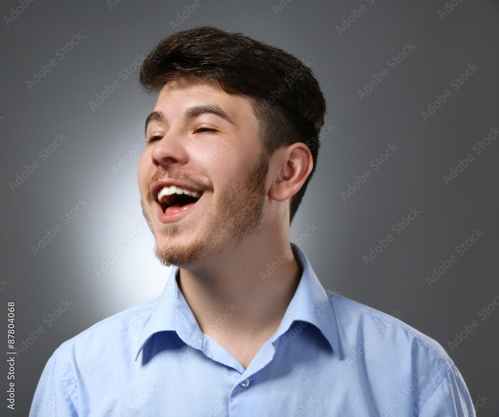 Portrait of smiling man on gray background Portrait of smiling man on gray background