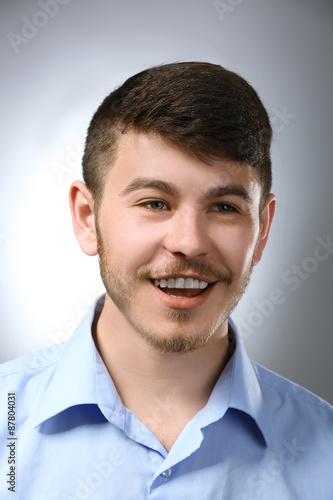 Portrait of smiling man on gray background