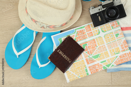 Summer vacation clothes, shoes and hat on wooden background