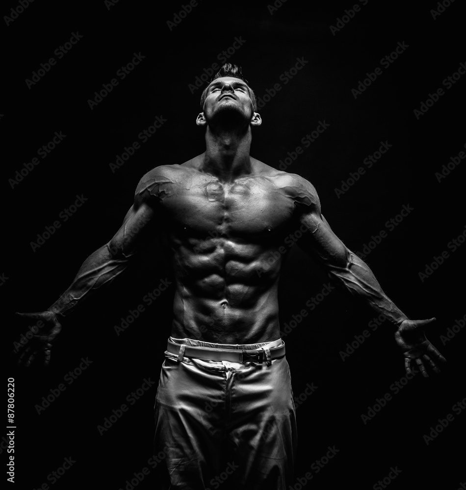 very muscular handsome athletic man on black background very muscular handsome athletic man on black background