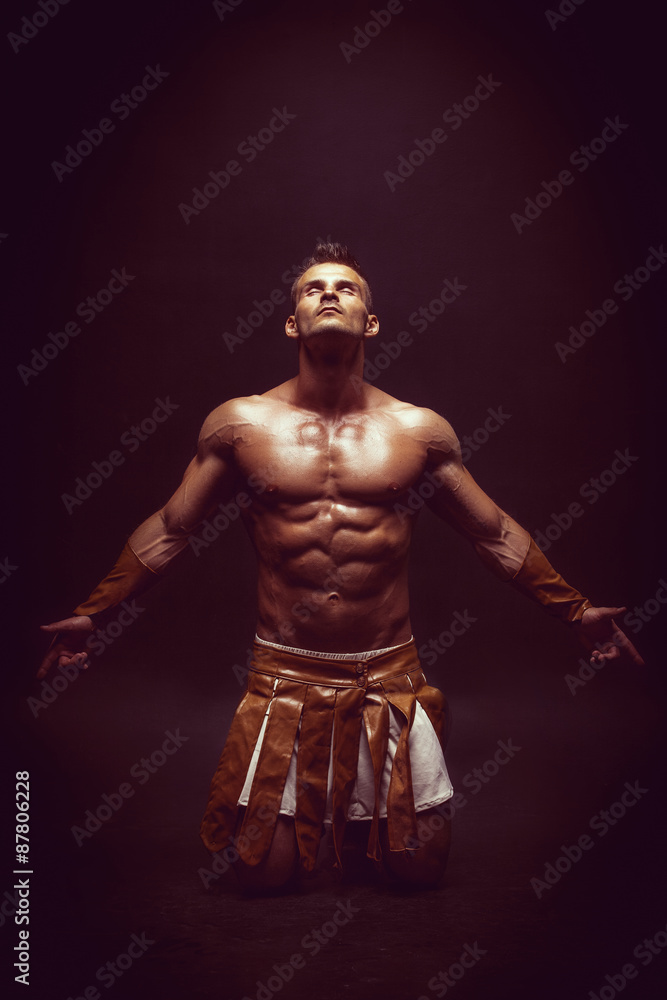 Rome warrior praying on the black background Rome warrior praying on the black background