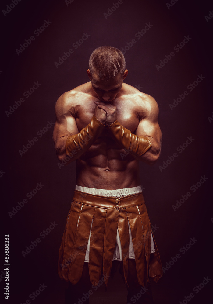 Rome warrior praying on the black background Rome warrior praying on the black background
