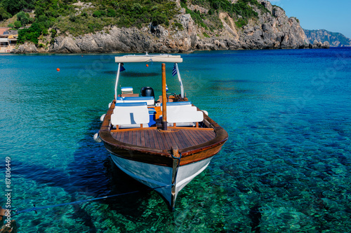 Greek  boat on sea in beautiful bay, Paleokastritsa bay on Corfu island, Greece