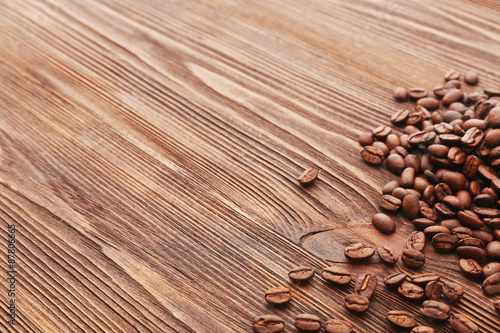 Coffee beans on wooden background © Africa Studio