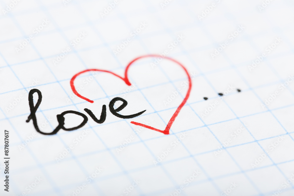 Word LOVE with heart written on sheet of paper background Word LOVE with heart written on sheet of paper background