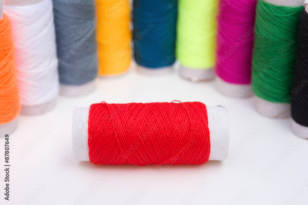 colorful bobbins on a white background colorful bobbins on a white background