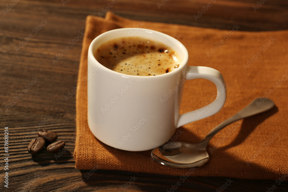Cup of coffee on napkin on table close up Cup of coffee on napkin on table close up