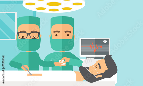 Two surgeons looking over a patient in an operating room