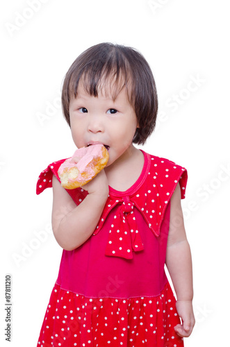 Little Asian girl eating donut over white