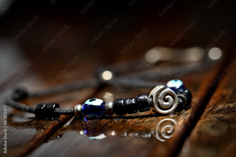 Hand made necklace on wodden wet background Hand made necklace on wodden wet background