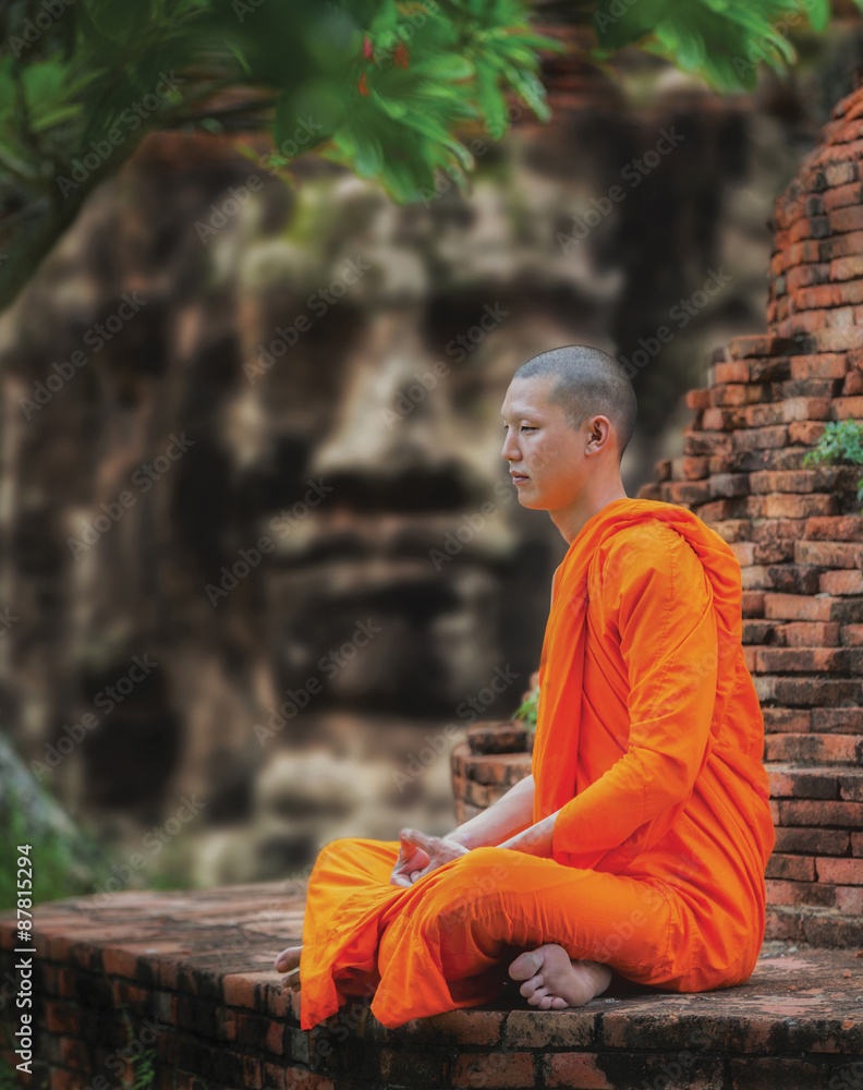 Fototapeta premium Angkor Wat monk. Ta Prohm Khmer ancient Buddhist temple in jungle forest. Famous landmark, place of worship and popular tourist travel destination in Asia