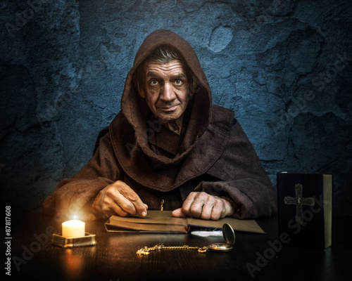 .Monk - priest.by candlelight - Bible reading photo