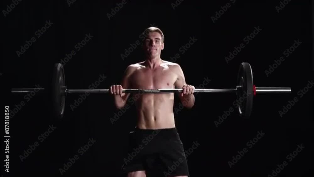Shirtless man performing a power clean Shirtless man performing a power clean
