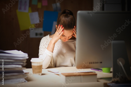 Young and beautiful businesswoman tired from work in the office photo