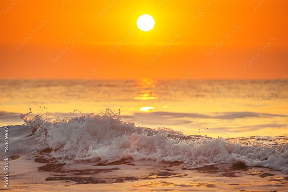 Sunrise and shining waves in ocean