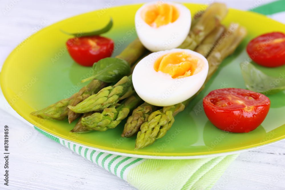 Plate of dietary salad with boiled asparagus and egg, closeup Plate of dietary salad with boiled asparagus and egg, closeup