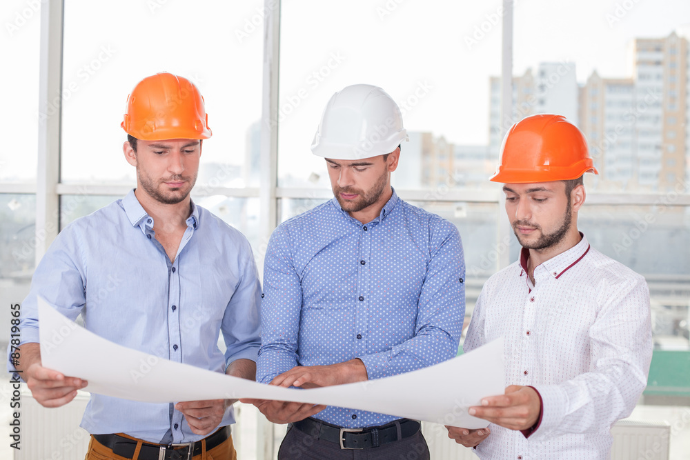 Attractive young erectors are working on a new project Attractive young erectors are working on a new project