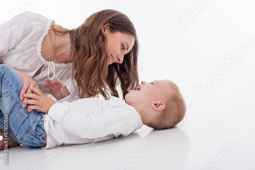Attractive young mother is playing with her son