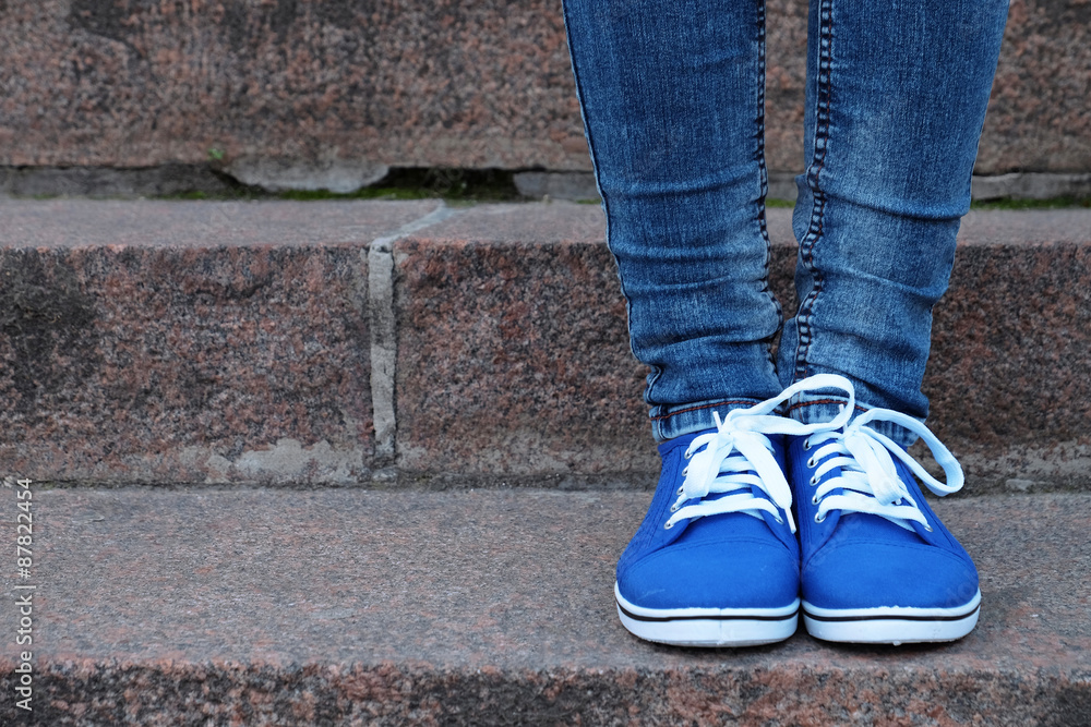 Female feet in gumshoes on stone stairs Female feet in gumshoes on stone stairs