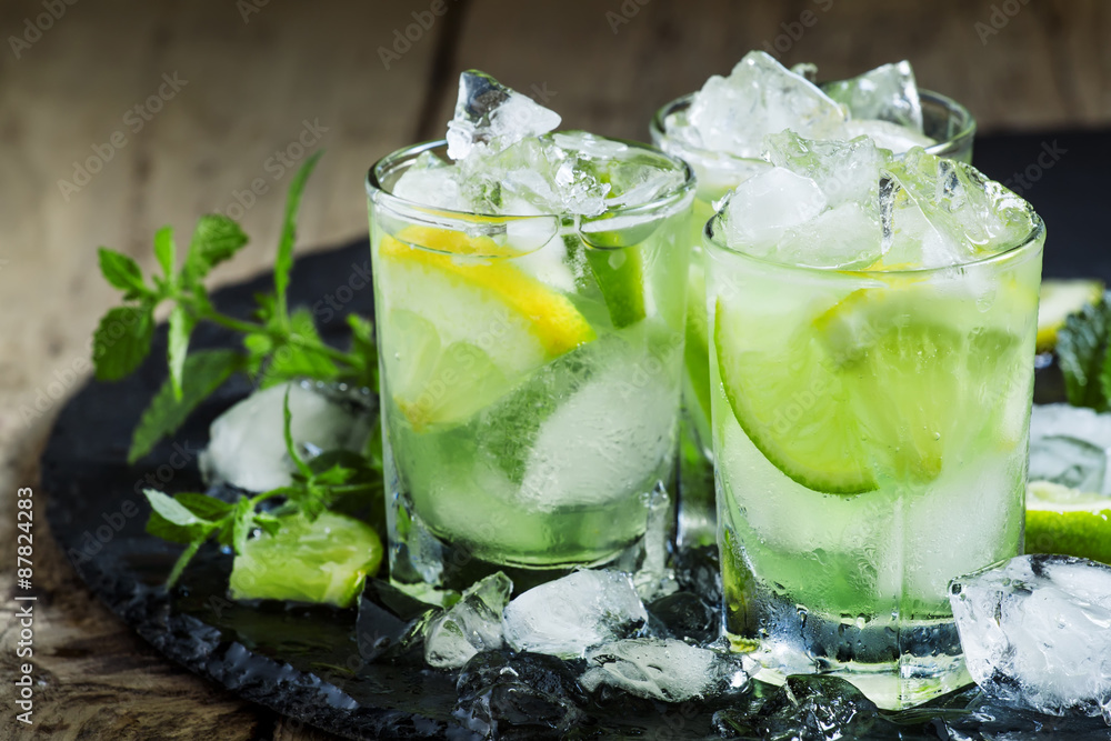 Lemon-lime green drink with crushed ice on a dark background, se