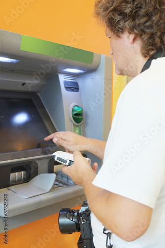 The man withdraws money from the ATM