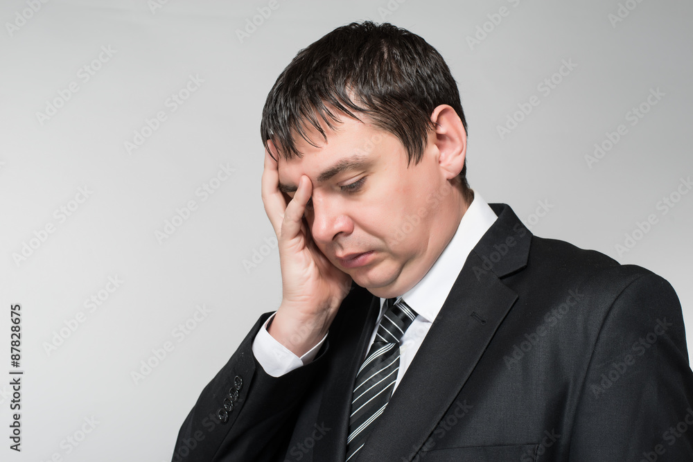 portrait of a young businessman hand covers the face portrait of a young businessman hand covers the face