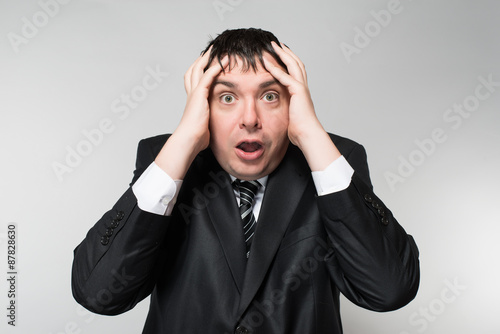 portrait of a young businessman panic fear