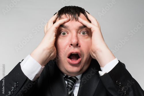 portrait of a young businessman panic fear