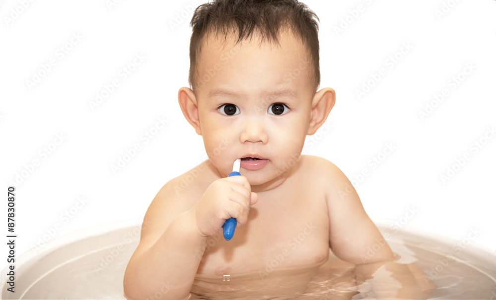 baby boy brushing teeth by blue color tooth brush,isolated on white background baby boy brushing teeth by blue color tooth brush,isolated on white background