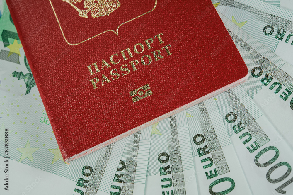 passport in the background of one hundred Euro banknotes in - time to travel passport in the background of one hundred Euro banknotes in - time to travel
