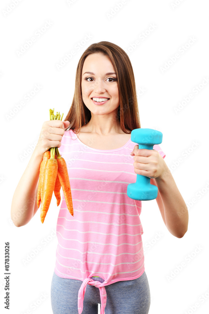 Healthy young woman with carrot and dumbbell isolated on white Healthy young woman with carrot and dumbbell isolated on white