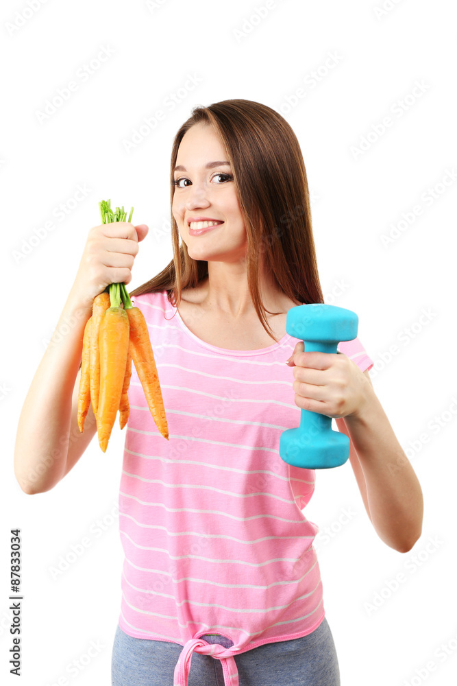 Healthy young woman with carrot and dumbbell isolated on white Healthy young woman with carrot and dumbbell isolated on white
