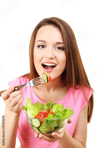 Young woman with glass bowl of diet salad isolated on white