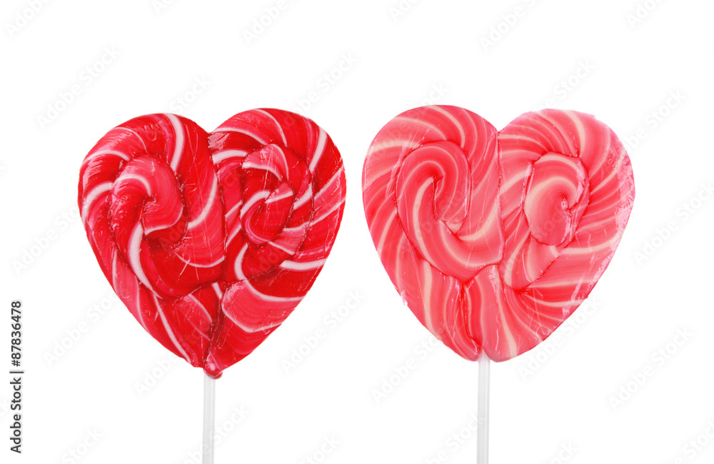 Two heart shaped lollipops isolated on white