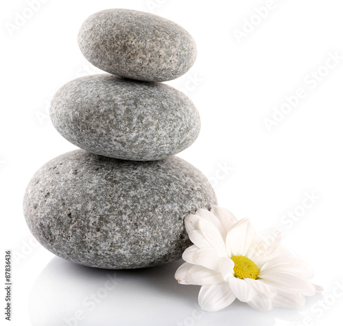 Stack of spa stones with chamomile isolated on white