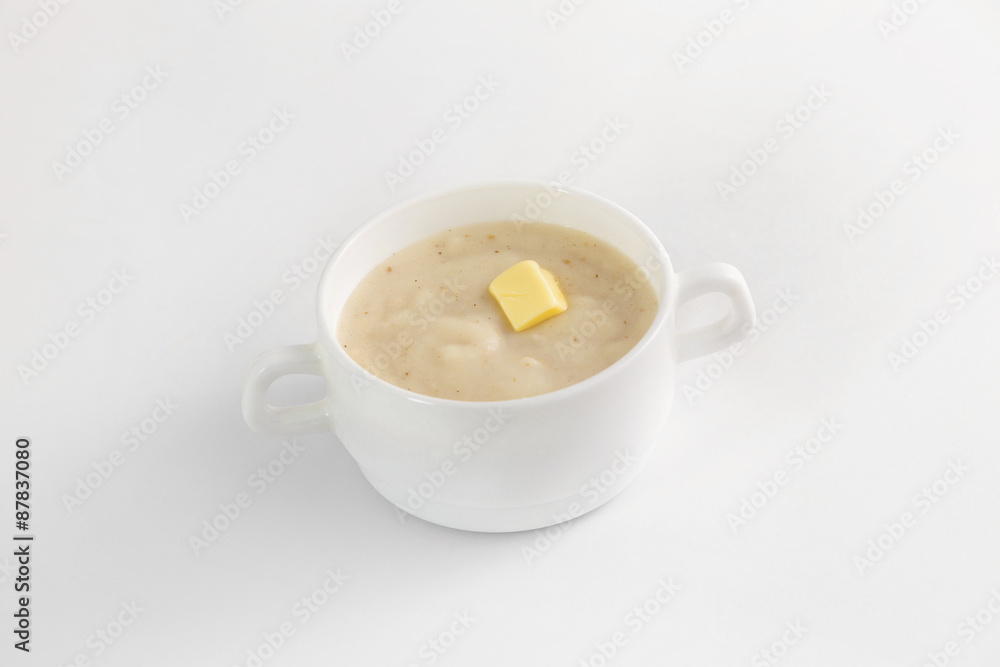 Bowl of semoline porridge with piece of butter isolated Bowl of semoline porridge with piece of butter isolated